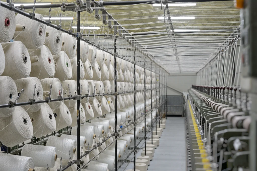 Hands working with yarn in production