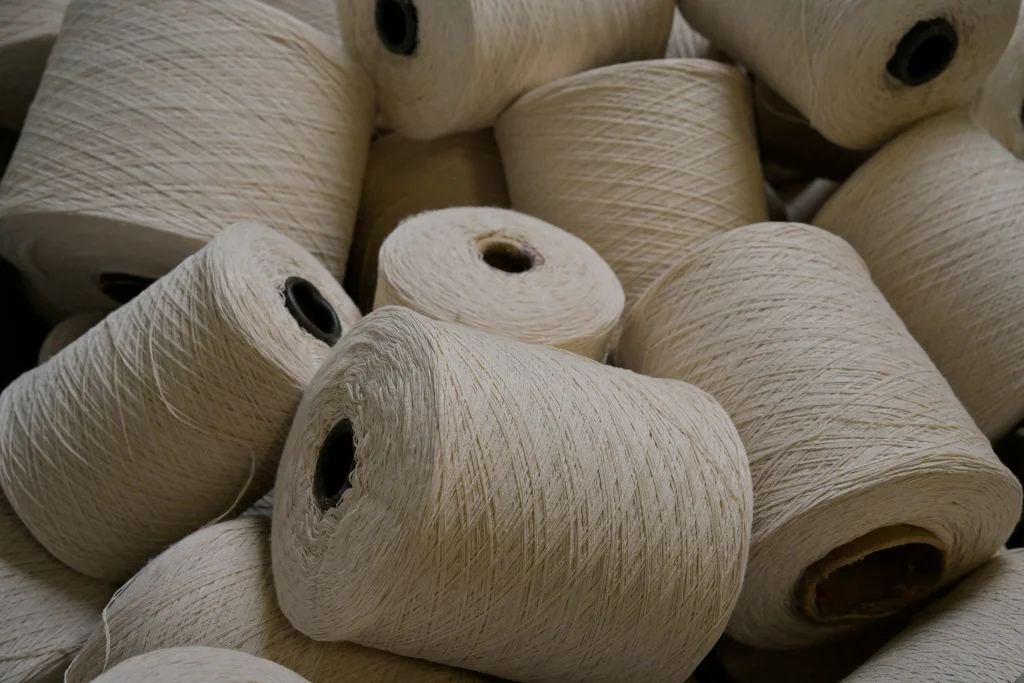 Hands working with hemp cord at the production facility